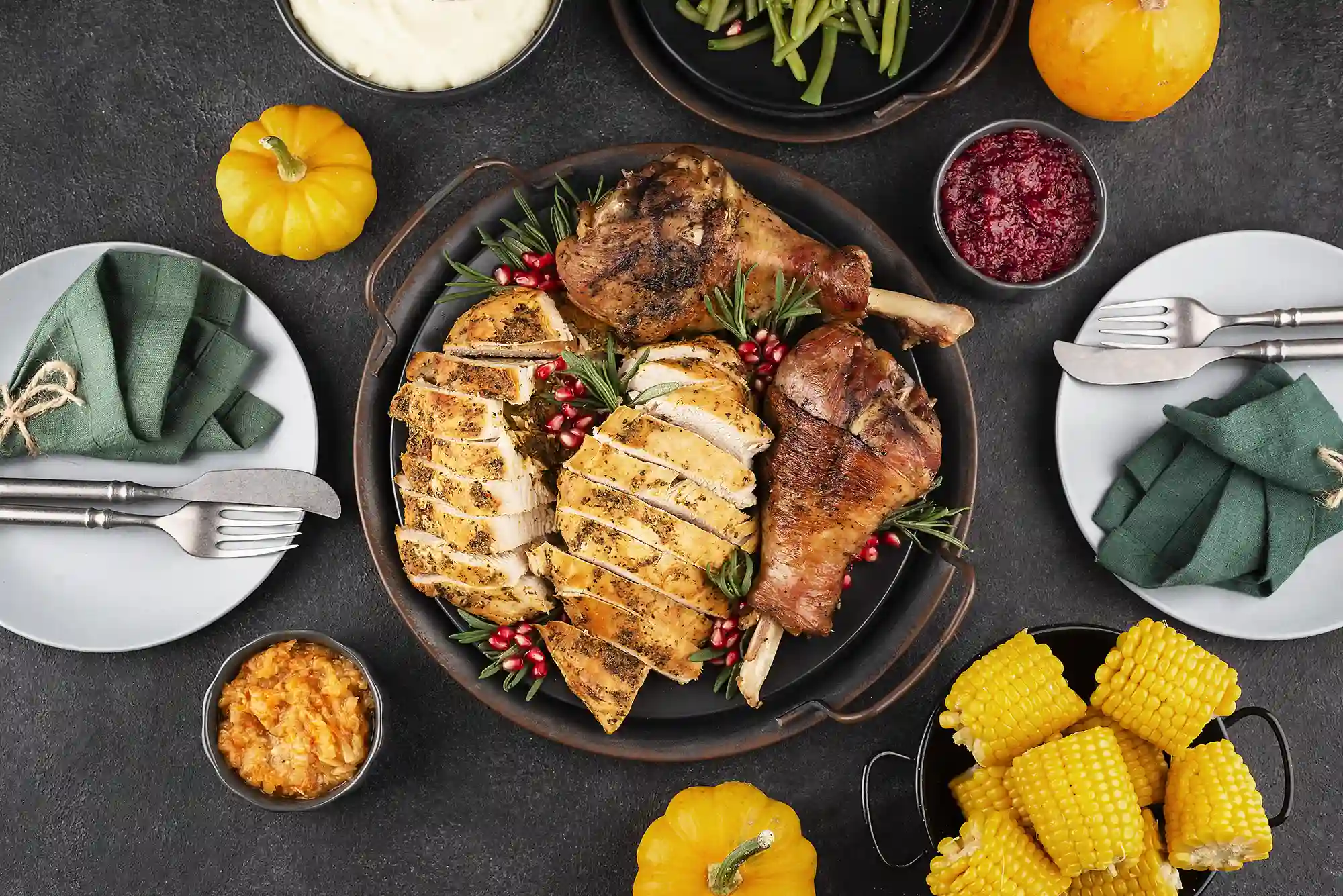Festive table with roast chicken, turkey, vegetables, and sauces, showing the joy and flavor at the heart of Delica Recipes.